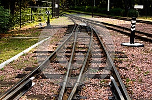 Narrow gauge railway tracks with switches and interchanges at Kyiv Children`s Railway in Syretsky Park