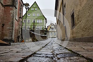 Narrow medieval street in old town Rothenburg ob der Tauber, Bavaria, Germany. November 2014