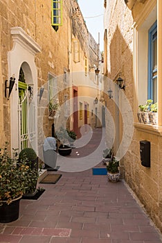 Narrow medieval street with stone houses in Mdina, Malta