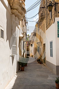 Narrow medieval street with stone houses in Mdina, Malta