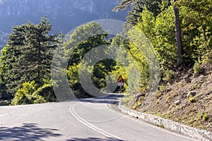 Narrow mountain road and  sign `steep climb`