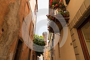 Narrow old cozy street in Lucca, Italy. Lucca is a city and comune in Tuscany. It is the capital of the Province of Lucca