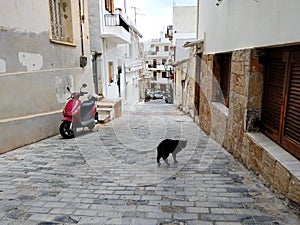 Narrow old street with tiny street cafes, Crete, Greece