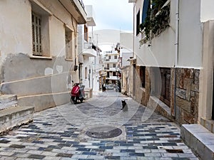 Narrow old street with tiny street cafes, Crete, Greece
