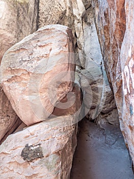 Narrow passage between big rocks in stone labyrinth Ostas rocks photo
