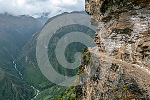 Narrow path on the hiking trail at high altitude Peruvian mountains between Maizal and Yanama, Peru photo