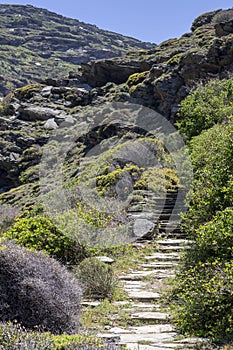 Narrow path in the mountains Cyclades, Andros Island, Greece