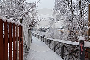 Narrow path with wooden fence for tourist to see the city view over the river, Stockholm