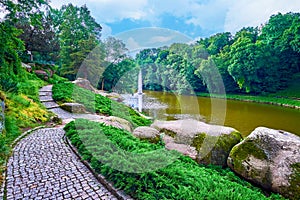 The narrow pathway along the shore of Ionian Sea lake in Sofiyivka Park, Uman, Ukraine