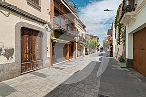 Narrow paved street with old buildings in Vilassar de Mar photo