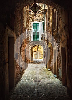 Narrow pedestrian street and cozy countryard in the old town of Dolceacqua, Imperia province, Liguria region, Italy