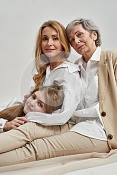 Narrow portrait of smiling three generations of women