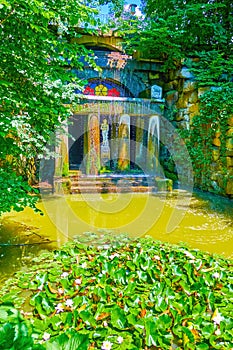 The narrow river with water lilies and Grotto of Venus on background, Sofiyivka Park, Uman, Ukraine