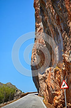 Narrow road cut in a mountain.