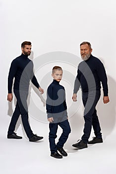 Narrow shot of three male generations on white background