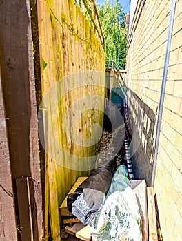 A Narrow Side Of House Area Used For Storage Or Small Access