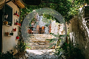 A narrow stone hillside alley with shops and homes in the ancient village of Sirince, Turkey