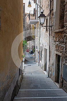 Narrow Street with Ancient Walls, antique Lamp Post in the Village of  Colonnata, Carrara- Italy