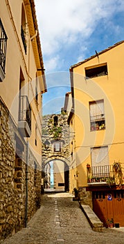 Narrow street with arch at end in medeival town of