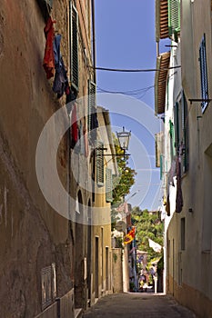 Narrow street in Asciano, Italy photo