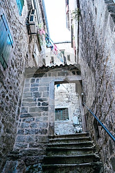 The narrow street of the authentic old town of Kotor, Montenegro. Old traditional stone houses. picturesque medieval street in the