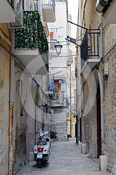 Narrow street of Bari Vecchia, houses, scooter
