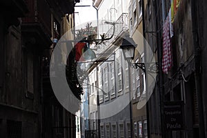 Narrow street of the city of Porto with the Portugal flag