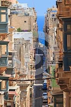 Narrow street, colorful balconies in Valletta, Malta photo