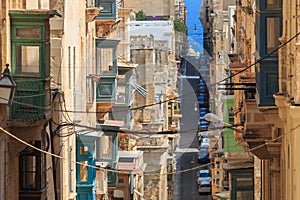 Narrow street, colorful balconies in Valletta, Malta photo