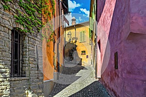 Narrow street among colorful houses in small italian town.