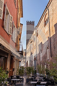 Narrow Street in Cremona with Tables and Chairs of a bar near the Municipal Building, Lombardy - taly