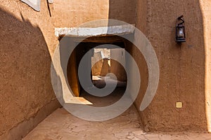 A narrow street with a crosswalk in the traditional Arab mud brick village