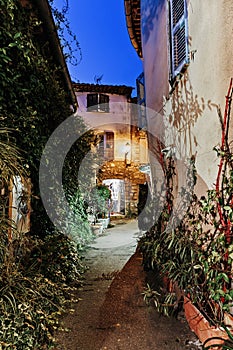 Narrow street with flowers in the old town Mougins in France.