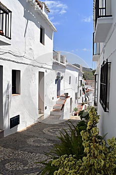 Narrow street and footpath in Frigiliana, Spanish white village Andalusia