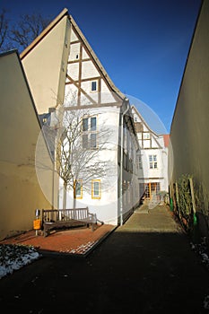 Narrow street with half-timbered houses listed as monuments in Greifswald, Germany