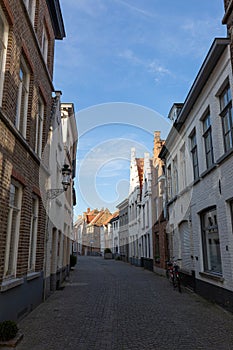 Narrow street between houses old town Brugge, Belgium