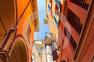 Narrow street lined with colorful buildings in Bologna historic center Italy