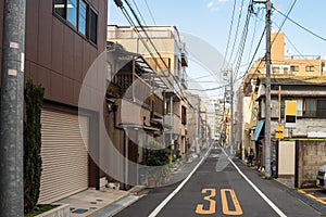 Narrow street lined with residential buildings in Tokyo