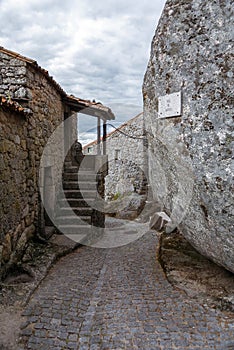 Narrow street of Monsanto vollage with rocks photo