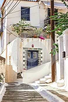 Narrow street in Neorio town on Poros island, Greece. Old white