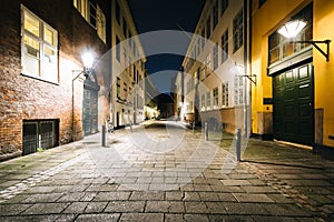 A narrow street at night, in Copenhagen, Denmark.