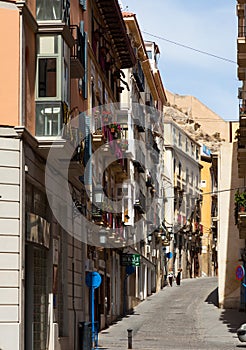 Narrow street in old european city. Alicante