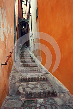 Narrow street of an old European city. Roussillon. France.