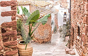 A narrow street between the old stone buildings in a small European town