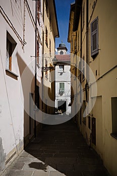 Narrow street in old town of Borgo Val di Taro, Parma province, Italy. Narrow cobbled street between old houses