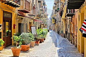 Narrow street in the old town of Cefalu, Sicily, Italy photo