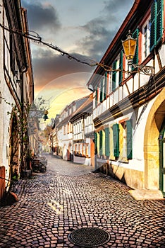 Narrow street in the old town of Neustadt an der Weinstrasse in the Pfalz at sunset, Germany