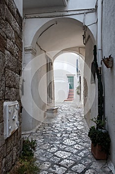 Narrow street in the old town, passage through the arch