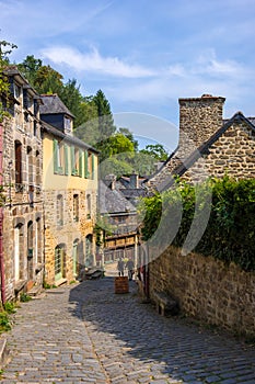 Narrow street with old traditional houses in histoical part of Dinan, Brittany, France