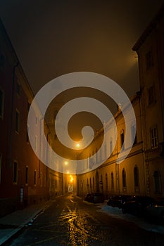 Narrow street in Parma at fuggy evening